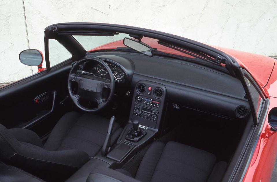 <p>Although snug, the Miata's two-seat cabin limits intrusions on passenger space. For example, the armrests are thin and stuck onto essentially flat door panels, the center console is narrow, and the footwells are surprisingly boxy and roomy. Taller drivers find that the tops of their heads stick up above the windshield header, and there is barely enough trunk space for a weekend getaway for two people (using soft-sided luggage). None of this matters, as the sprightly Miata causes a sensation at dealerships across the country<br></p>