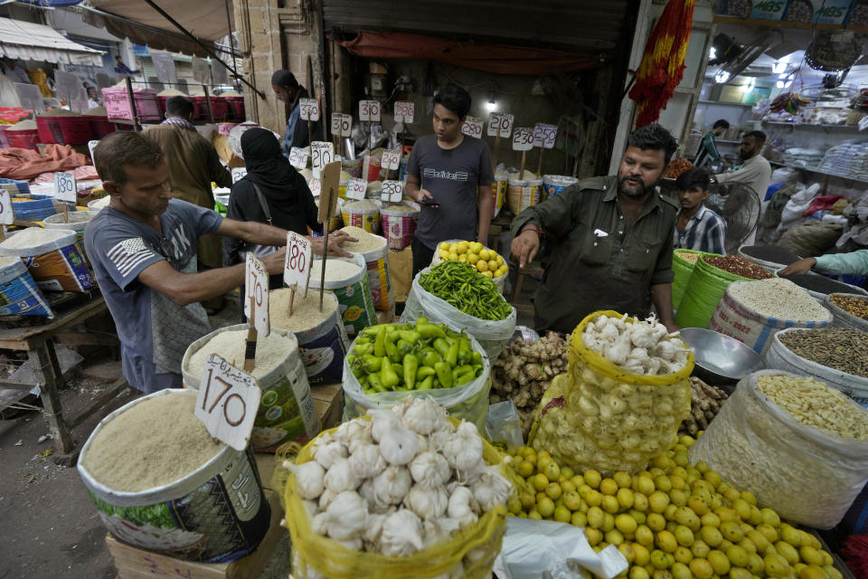 People buy rice and other items at a market, in Karachi, Pakistan, Thursday, July 13, 2023. Pakistan’s finance minister on Thursday said the International Monetary Fund deposited a much-awaited first installment of $1.2 billion with the country’s central bank under a recently signed bailout aimed at enabling the impoverished Islamic nation to avoid defaulting on its debt repayments. (AP Photo/Fareed Khan)