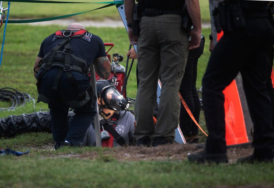 Emergency officials work a scene on Hill Avenue next to the Fort Myers Country Club on on Wednesday, May 22, 2024. A woman is dead after intentionally entering a storm drain system. Emergency and public works officials worked for hours to try to rescue her but she died.