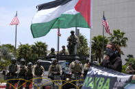 Police officers stand guard during in a protest outside the Federal Building against Israel and in support of Palestinians, Saturday, May 15, 2021 in the Westwood section of Los Angeles. (AP Photo/Ringo H.W. Chiu)