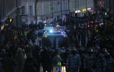 Law enforcement officers stand guard after a rally to demand authorities allow opposition candidates to run in a local election in Moscow