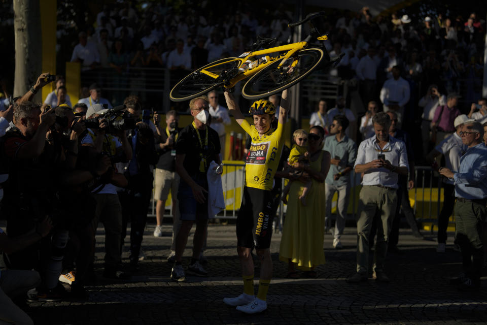 Tour de France winner Denmark's Jonas Vingegaard, wearing the overall leader's yellow jersey, celebrates after the twenty-first stage of the Tour de France cycling race over 116 kilometers (72 miles) with start in Paris la Defense Arena and finish on the Champs Elysees in Paris, France, Sunday, July 24, 2022. (AP Photo/Thibault Camus)