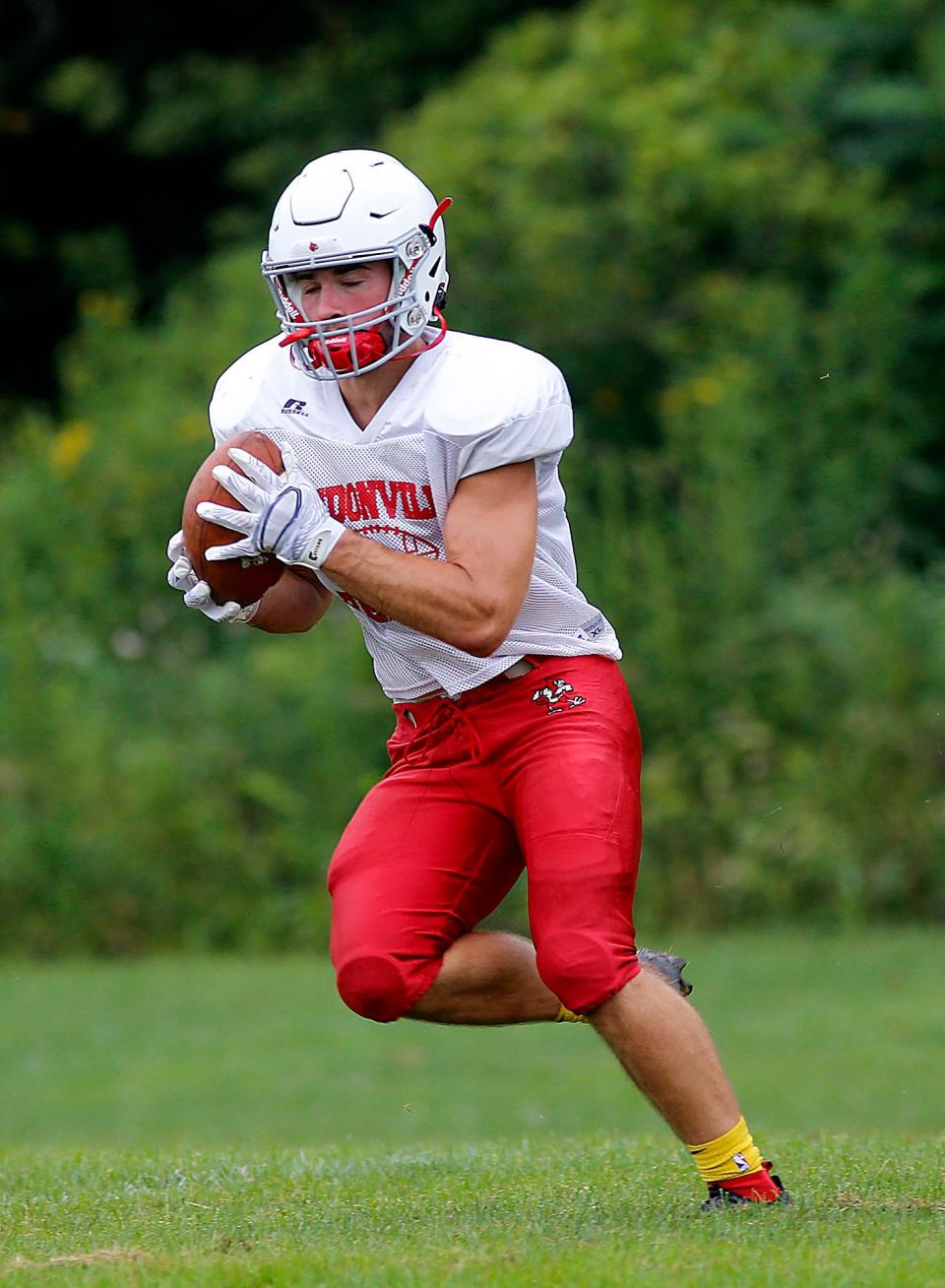 Micah Simpson pulls in a pass during the first day of high school football practice on Aug. 1 this year at Loudonville High School.