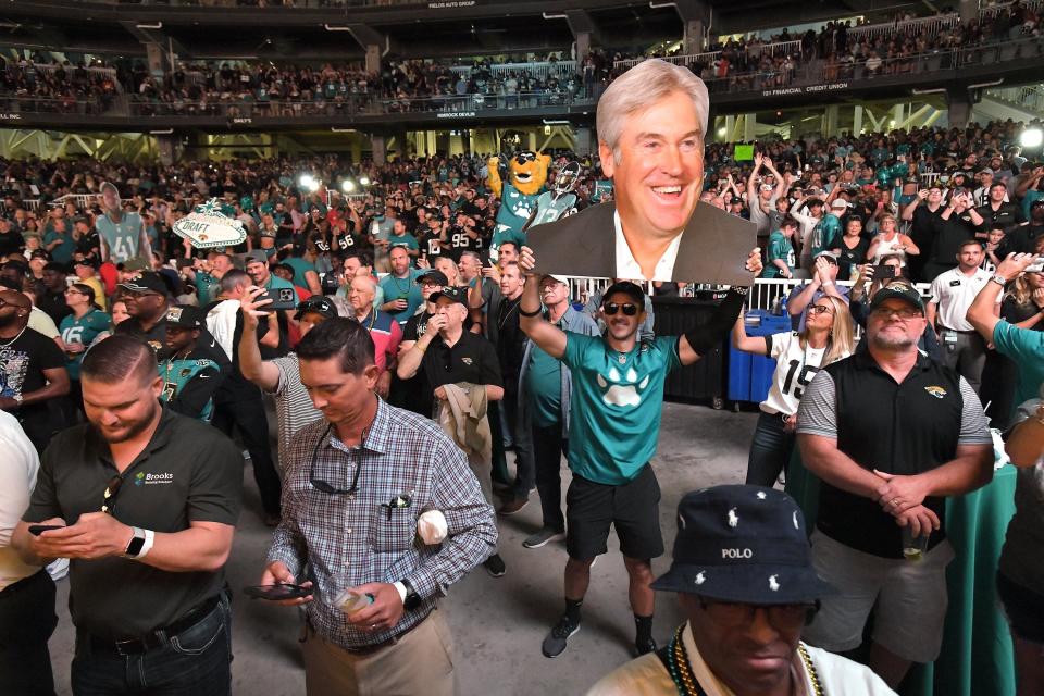 A Jaguars fan holds a oversized photo of the team's new head coach, Doug Pederson during the announcement of the team's first round draft pick Thursday evening. Jacksonville Jaguar fans showed up at Daily's Place for the 2022 NFL Draft party which saw the Jaguars pick University of Georgia edge rusher Travon Walker as their first pick of the draft where the team had the first overall draft pick Thursday evening, April 28, 2022. [Bob Self/Florida Times-Union]