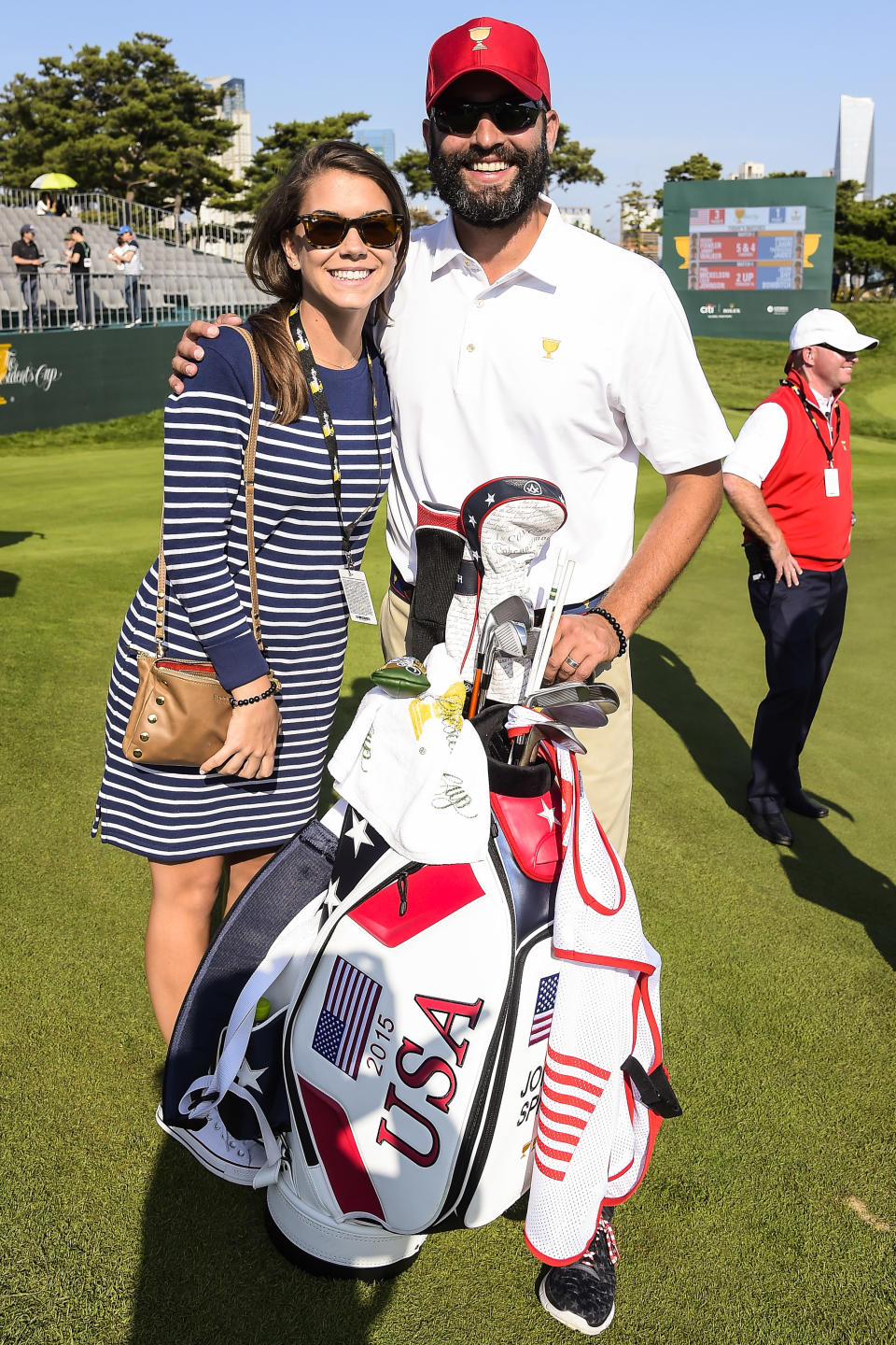 INCHEON CITY, SOUTH KOREA - OCTOBER 08: Annie Verret, girlfriend of Jordan Spieth of Team USA, and Spieth's caddie Michael Greller pose for a photo during the first round of The Presidents Cup at Jack Nicklaus Golf Club Korea on October 8, 2015 in Songdo IBD, Incheon City, South Korea. (Photo by Chris Condon/PGA TOUR)