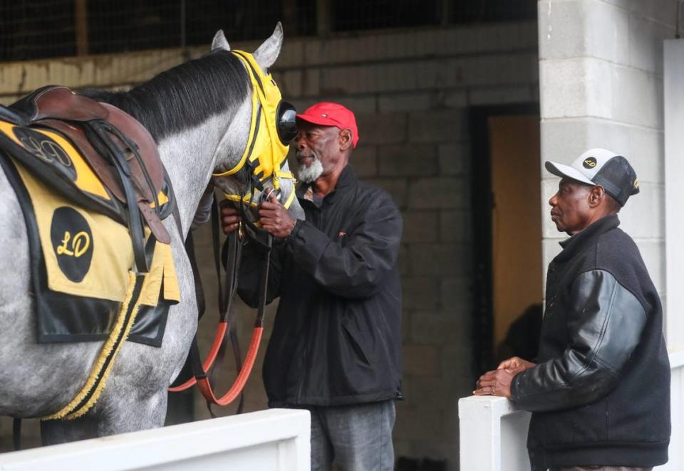 Trainer Larry Demeritte, right, and his brother, Patrick Demeritte, prepare West Saratoga for a morning workout. West Saratoga is Larry Demeritte’s first Kentucky Derby runner.