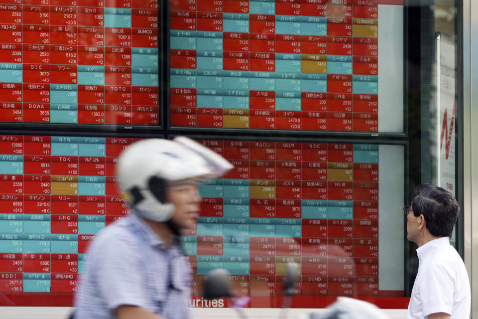 A man looks at an electronic stock board showing Japan's Nikkei 225 index at a securities firm in Tokyo Thursday, Sept. 12, 2019. Asian shares were mixed Thursday after China moved to ease trade tensions. (AP Photo/Eugene Hoshiko)