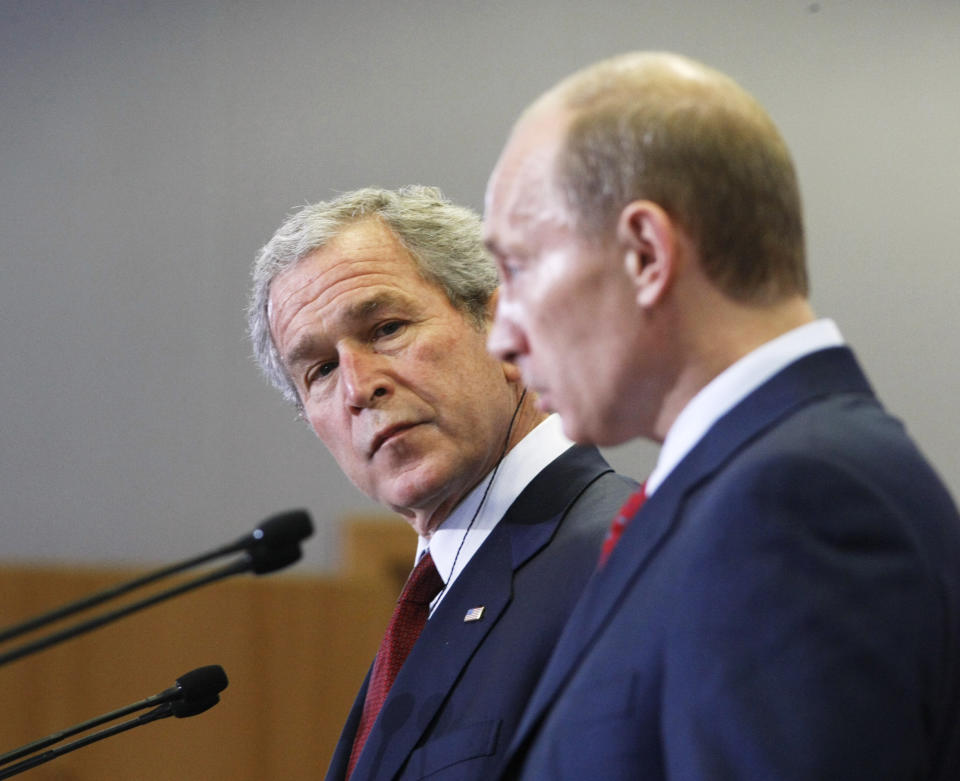 FILE - In this April 6, 2008 file photo, President George Bush, left, and Russian President Vladimir Putin, look on during a press conference at the Russian Presidential residence Bochorov Ruchei, in Sochi, Russia. (AP Photo/Gerald Herbert)