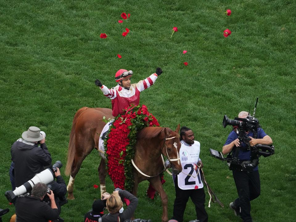 Jockey Sonny Leon tossed roses into the air in celebration after winning the 148th running of the Kentucky Derby aboard Rich Strike. May 7, 2022