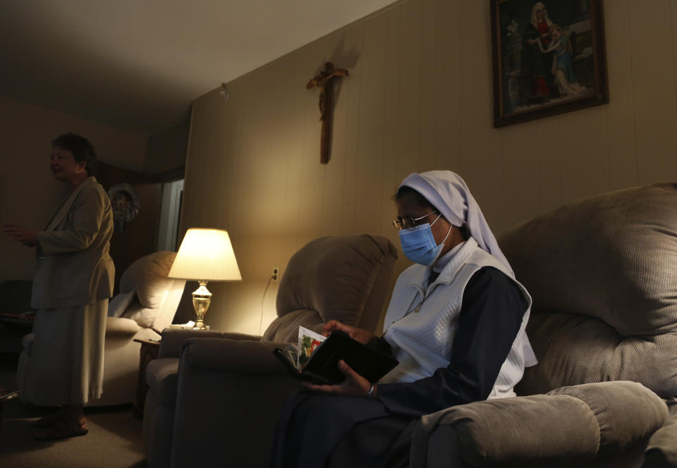 Sister Rose Nellivila sits for morning prayer at St. Anne Home in Greensburg, Pa., where she serves as a nurse for residents of the nursing facility, on Thursday, March 25, 2021. Nellivila contracted the coronavirus last fall and made a full recovery, but a fellow nun, Sister Mary Evelyn Labik, died in October. (AP Photo/Jessie Wardarski)