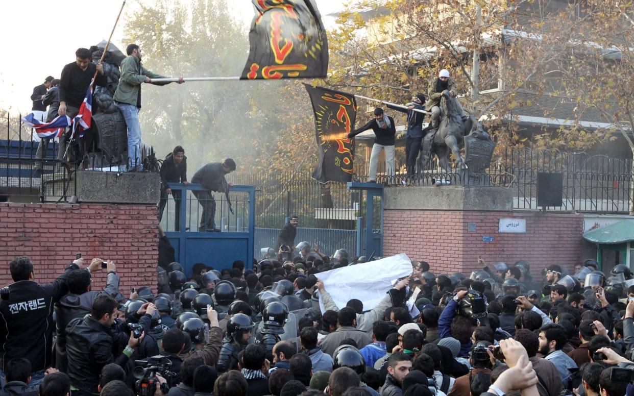 Iranian protesters break into the British embassy and bring down the British flag in Tehran on November 29, 2011.  - AFP