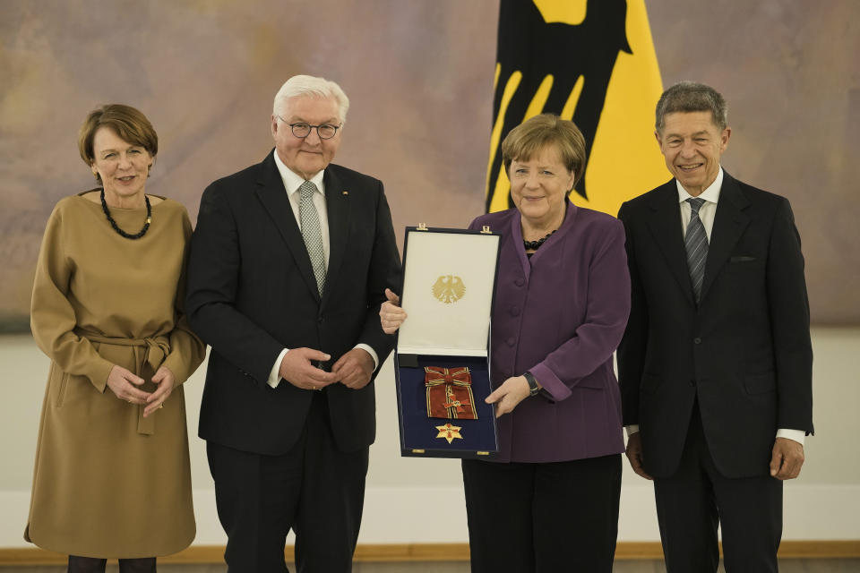 German President Frank-Walter Steinmeier, second left, and his wife Elke Buedenbender, left, pose with former Chancellor Angela Merkel, second right, and her husband Joachim Sauer, right, during a reception to honor Merkel with the Grand Cross of the Order of Merit of the Federal Republic of Germany in a special design at Bellevue Palace in Berlin, Germany, Monday, April 17, 2023. (AP Photo/Markus Schreiber)