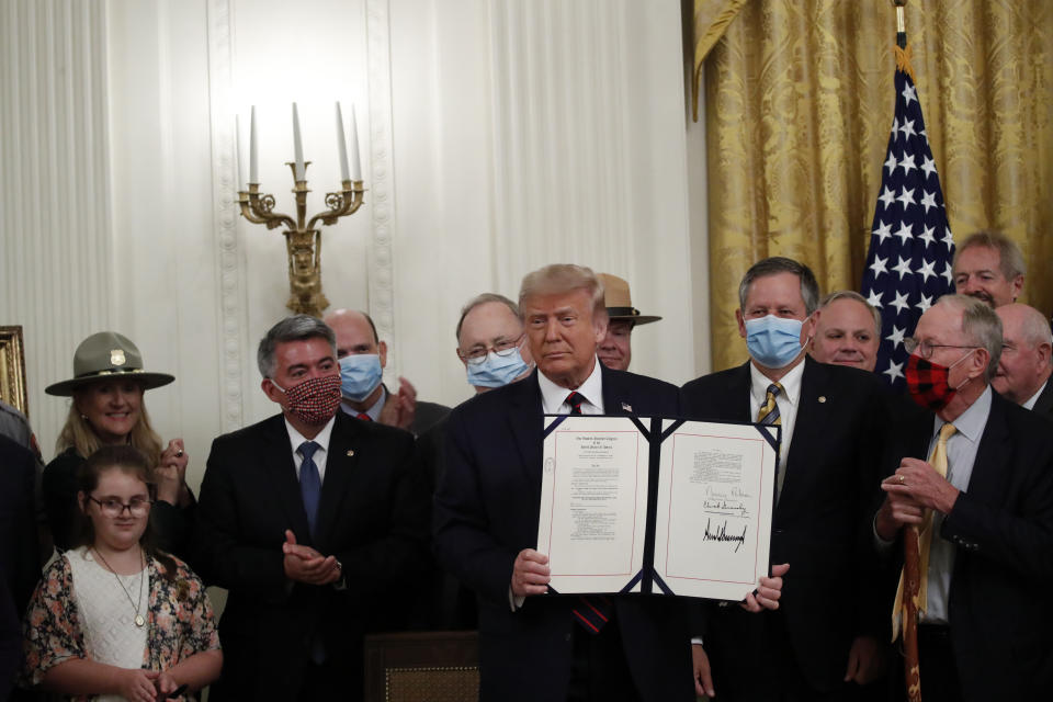 President Donald Trump poses for a photo during a signing ceremony for H.R. 1957 – "The Great American Outdoors Act," in the East Room of the White House, Tuesday, Aug. 4, 2020, in Washington. (AP Photo/Alex Brandon)