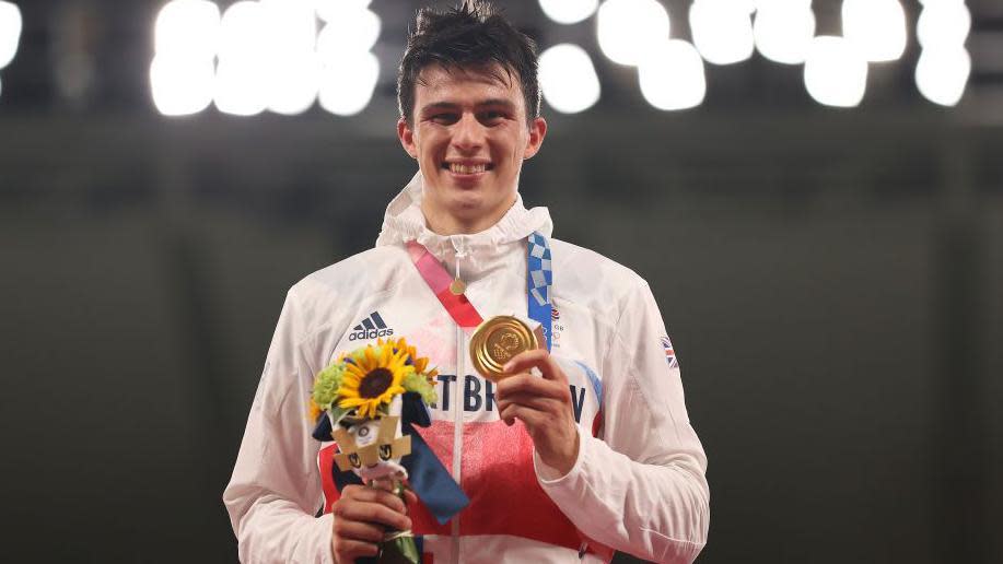 Joe Choong with his Olympic gold at Tokyo 2020