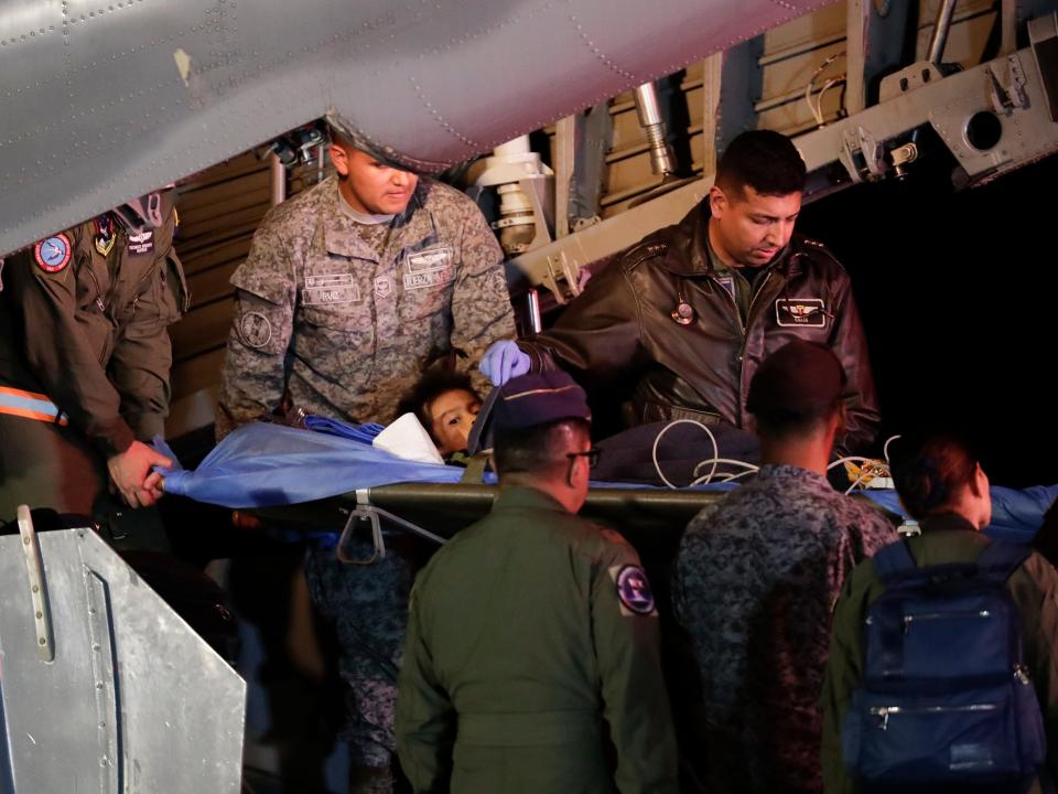 Military personnel unload from a plane one of four Indigenous children who were missing after a deadly plane crash at the military air base in Bogota, Colombia, Saturday, June 10, 2023. The children survived a small plane crash 40 days ago and had been the subject of an intense search in the jungle.