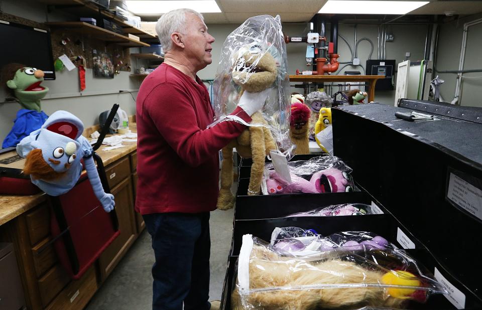 Stan Rabe, the producer of "Avenue Q," shows puppet characters from New York City for the performance of the musical puppet show at ACTORS Theater in Ames.