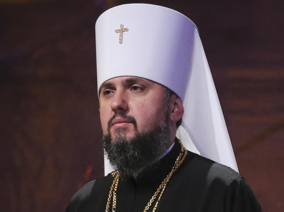 A new head of independent Ukrainian church Metropolitan of Kiev Epiphanius greets people gathered to support independent Ukrainian church near the St. Sophia Cathedral in Kiev, Ukraine, Saturday, Dec. 15, 2018. Ukrainian Orthodox leaders say they have approved the creation of a unified church independent of the Moscow Patriarchate and elected a leader to head the new church. (AP Photo/Efrem Lukatsky)