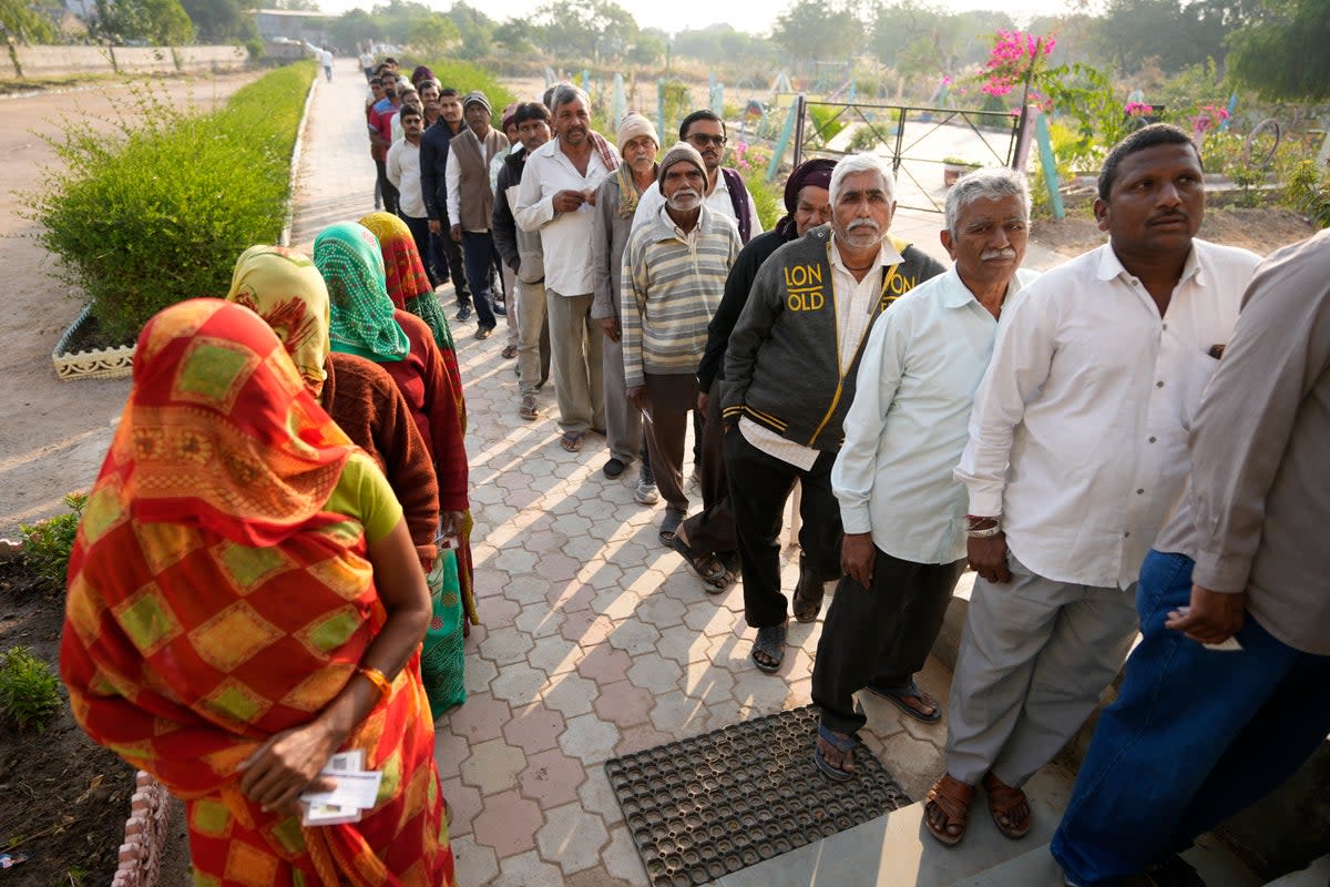 File photo: People stand in queue to cast their votes during the first phase of Gujarat state legislature elections in Limbadi, India in December 2022  (AP)