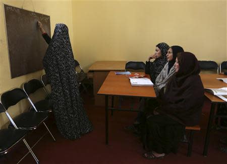 Afghan female prisoners attend an English language class at Herat's prison for women in Herat, western Afghanistan, December 8, 2013. REUTERS/Omar Sobhani