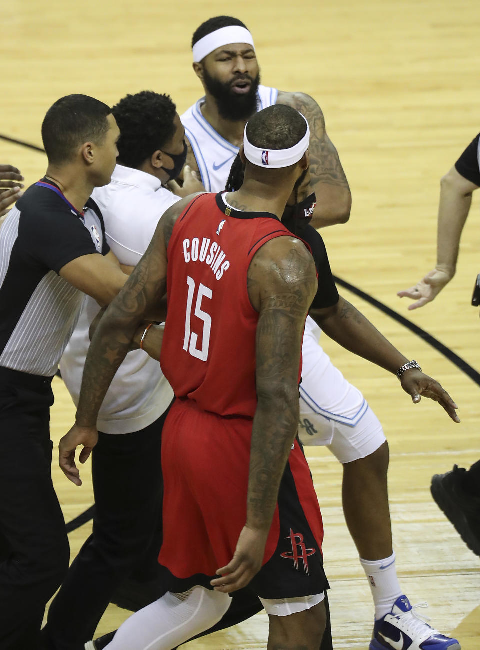 Los Angeles Lakers forward Markieff Morris, top, gets into an altercation with Houston Rockets center DeMarcus Cousins (15) during the first quarter of an NBA basketball game on Sunday, Jan. 10, 2021, at Toyota Center in Houston. Morris was ejected from the game after the incident. (Brett Coomer/Houston Chronicle via AP)