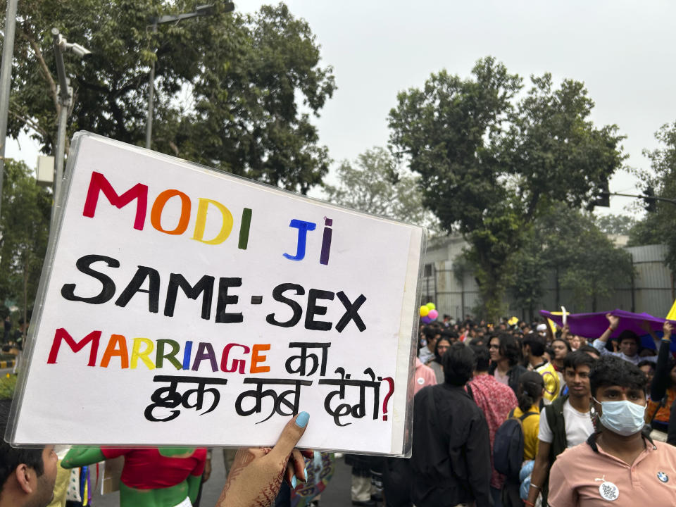 A placard written in Hindi and English saying 'Modi ji, when will you allow same-sex marriage?' Is carried by a participant of the Delhi Queer Pride Parade in New Delhi, India, Sunday, Nov. 26, 2023. This annual event comes as India's top court refused to legalize same-sex marriages in an October ruling that disappointed campaigners for LGBTQ+ rights in the world's most populous country. (AP Photo/Shonal Ganguly)