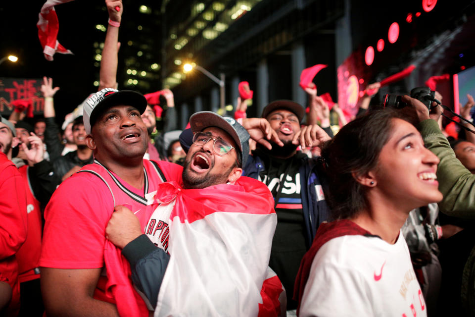 Fans celebrate after the Toronto Raptors defeated the Golden State Warriors in Oakland, California in Game Six of the best-of-seven NBA Finals, in Toronto, Ontario, Canada, June 14, 2019.   REUTERS/Andrew Ryan