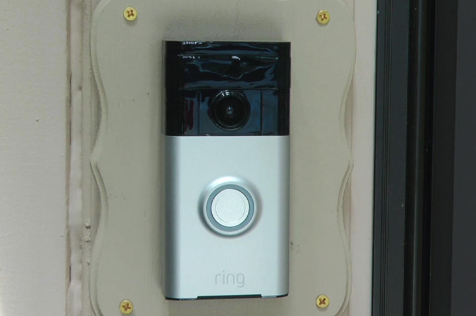 FILE - In this Friday, June 28, 2019, image made from video, a Ring doorbell camera is shown at a home in Coon Rapids, Minn. From what you buy online, to how you remember tasks, to when you monitor your doorstep, Amazon is seemingly everywhere. And it appears the company doesn’t want to halt its reach anytime soon. In recent weeks, Amazon has said it will spend billions of dollars in two gigantic acquisitions that, if approved, will broaden its ever growing presence in the lives of consumers. (AP Photo/Jeff Baenen, File)