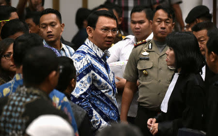FILE PHOTO: Jakarta's Christian governor Basuki Tjahaja Purnama (L), popularly known as Ahok, speaks to his lawyers after his sentencing during the guilty verdict in his blasphemy trial in Jakarta on May 9, 2017. REUTERS/Bay Ismoyo/Pool/File Photo