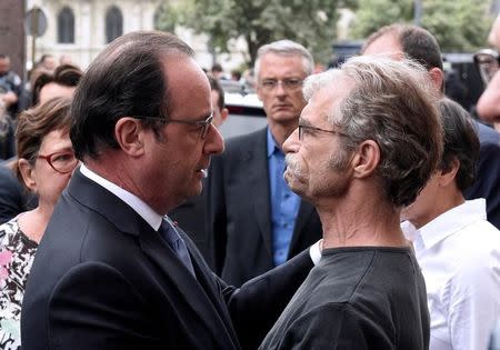 French President Francois Hollande (L) speaks with Mayor Hubert Wulfranc as he arrives as he arrives after a hostage-taking at a church in Saint-Etienne-du-Rouvray, France, July 26, 2016. REUTERS/Boris Maslard/Pool