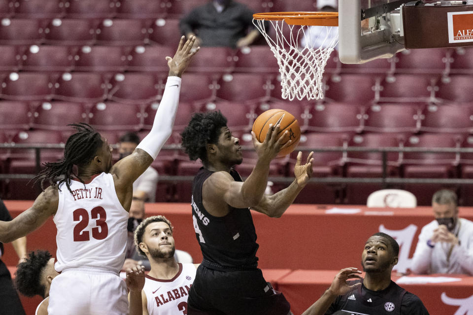 Mississippi State guard/forward Cameron Matthews (4) shoots by Alabama guard John Petty Jr. (23) during the first half of an NCAA college basketball game, Saturday, Jan. 23, 2021, in Tuscaloosa, Ala. (AP Photo/Vasha Hunt)