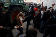 A Spanish Civil Guard officer scuffles with a woman outside a polling station for the banned independence referendum where Catalan President Carles Puigdemont was supposed to vote in Sant Julia de Ramis, Spain October 1, 2017. REUTERS/Juan Medina 