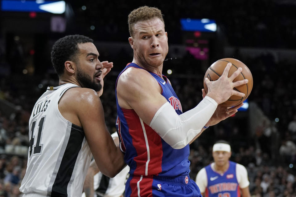 Detroit Pistons' Blake Griffin, right, drives against San Antonio Spurs' Trey Lyles during the first half of an NBA basketball game Saturday, Dec. 28, 2019, in San Antonio. (AP Photo/Darren Abate)