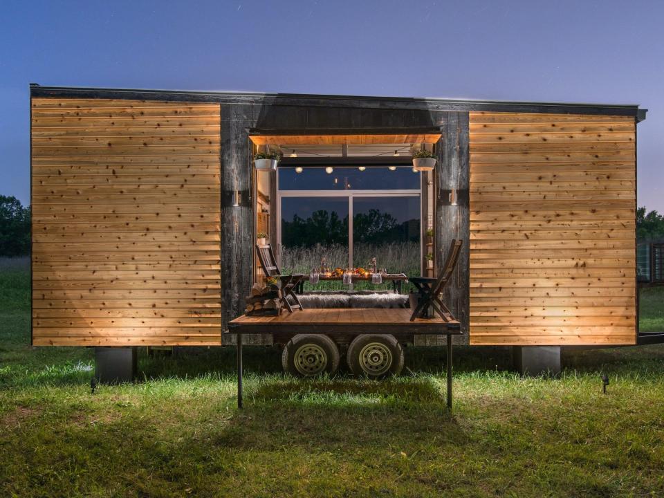 a wooden tiny home with an extended terrace