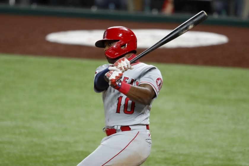 Los Angeles Angels' Justin Upton (10) follows through on a swing in a baseball game against the Texas Rangers in Arlington, Texas, Friday, Aug. 7, 2020. (AP Photo/Tony Gutierrez)