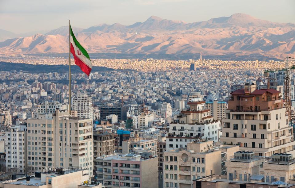 An Iranian flag above Tehran