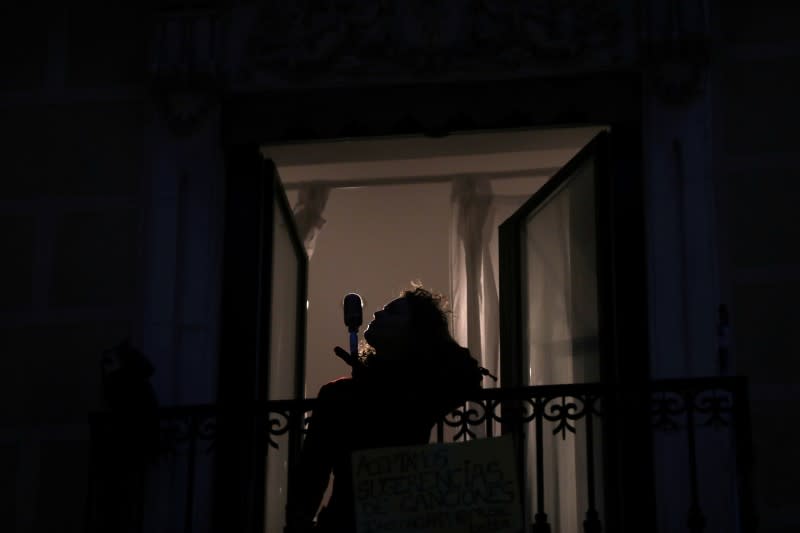 Spanish blues singer "Betta" sings from her balcony during a daily evening concert to support health workers and to make it easier for her neighbours to bear the coronavirus lockdown in Madrid