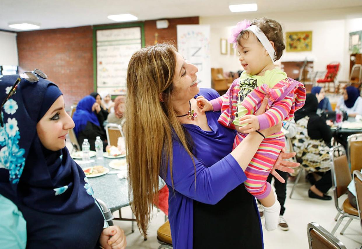 Zoe Sahloul, executive director of the New England Arab American Organization, center, celebrates Eid-al-Fitr in Maine. <a href="https://www.gettyimages.com/detail/news-photo/zoe-sahloul-executive-director-of-the-new-england-arab-news-photo/546505856?adppopup=true" rel="nofollow noopener" target="_blank" data-ylk="slk:Joel Page/Portland Portland Press Herald via Getty Images;elm:context_link;itc:0;sec:content-canvas" class="link ">Joel Page/Portland Portland Press Herald via Getty Images</a>