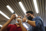 Prime Minister Justin Trudeau poses for a photo as he greets commuters at a Montreal Metro station on Tuesday, Sept. 21, 2021. Trudeau’s Liberal Party has secured victory in parliamentary elections but failed to get the majority he wanted in a vote that focused on the coronavirus pandemic but that many Canadians saw as unnecessary. (Sean Kilpatrick/The Canadian Press via AP)