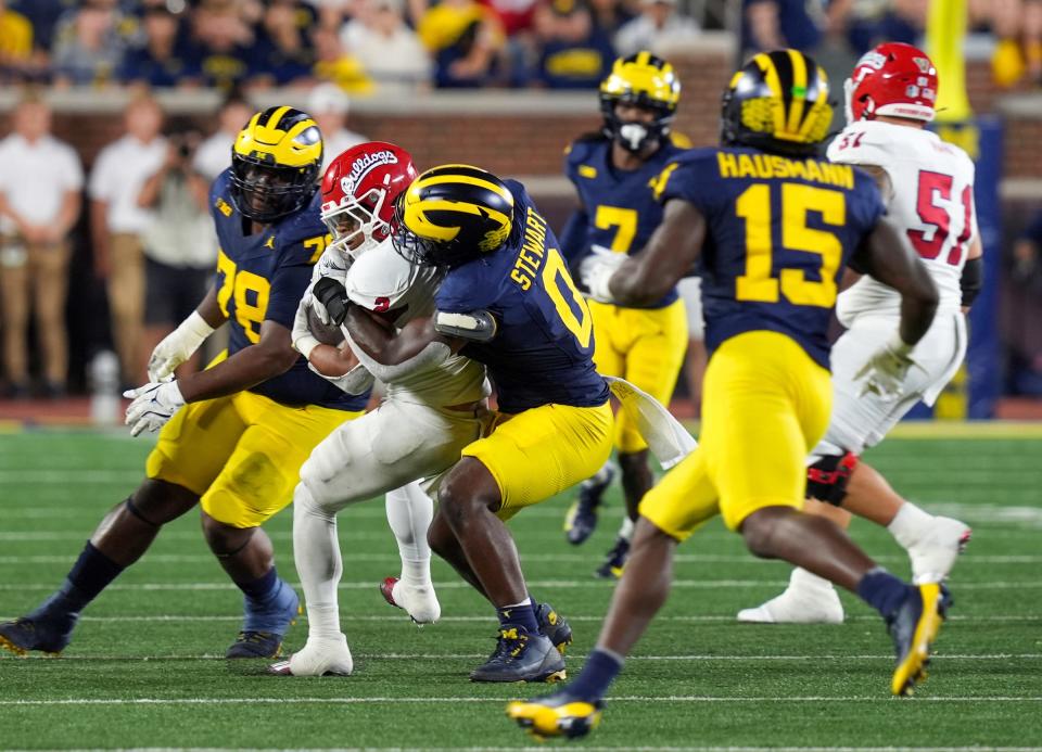 Michigan edge rusher Josaiah Stewart (0) tackles Fresno State running back Malik Sherrod (2) during the second half at Michigan Stadium in Ann Arbor on Saturday, Aug. 31, 2024.