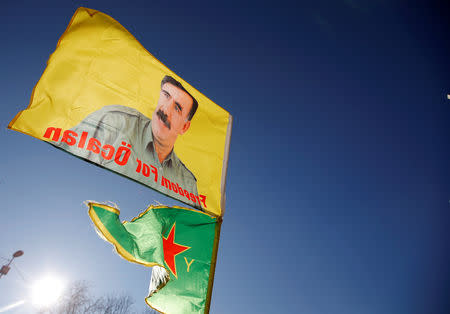 FILE PHOTO: Pro-Kurd protesters hold flags with portraits of jailed Kurdistan Workers Party (PKK) leader Abdullah Ocalan as they take part in a demonstration in support to him in Strasbourg, France, February 16, 2019. REUTERS/Vincent Kessler