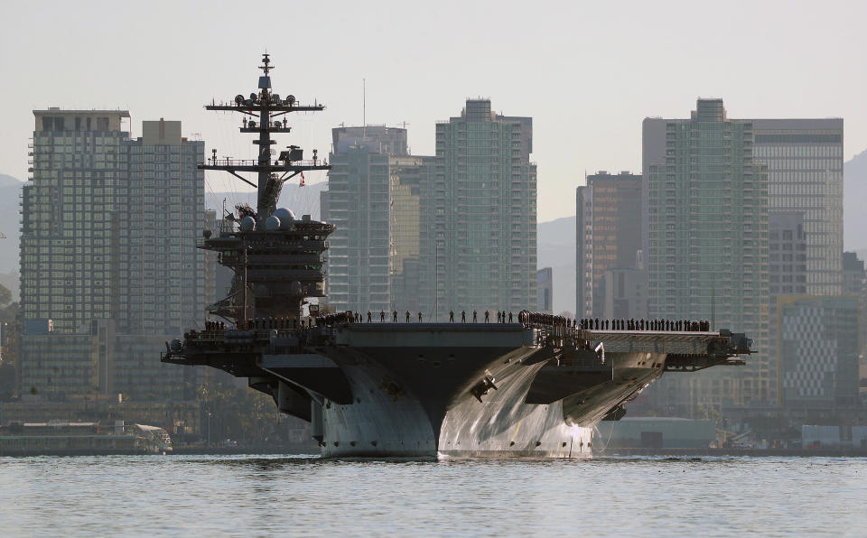 FILE - Sailors and marines line the deck of the aircraft carrier USS Abraham Lincoln (CVN-72) as it deploys from San Diego, Jan. 3, 2022. Illinois is adding tens of thousands of people to its population total, and California is getting misplaced sailors on the aircraft carrier put in the right location, after successfully asking for a review of their 2020 census figures. (K.C. Alfred/The San Diego Union-Tribune via AP, File)