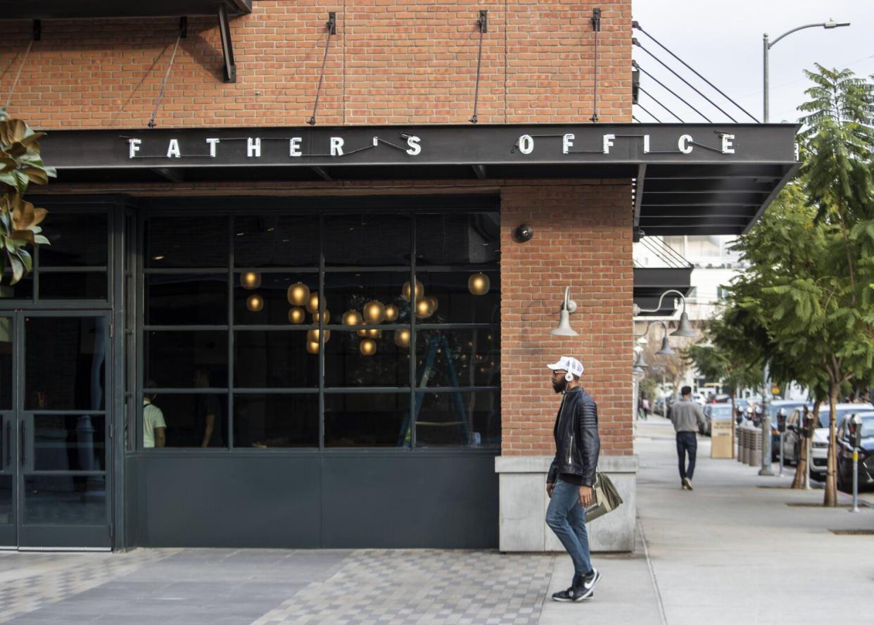 Exterior of a restaurant with a person walking by