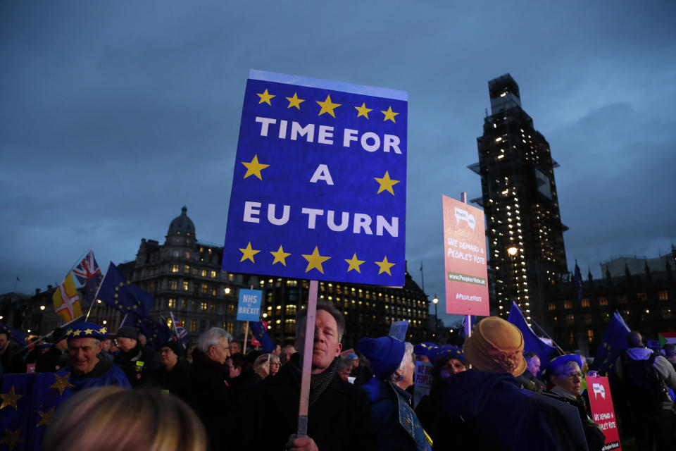 Pro-European demonstrators hold posters at Parliament Square in London, Tuesday, Jan. 15, 2019. Britain's Prime Minister Theresa May is struggling to win support for her Brexit deal in Parliament. Lawmakers are due to vote on the agreement Tuesday, and all signs suggest they will reject it, adding uncertainty to Brexit less than three months before Britain is due to leave the EU on March 29. (AP Photo/Frank Augstein)