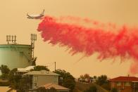 A water bombing plane drops fire retardant on a bushfire in Harrington