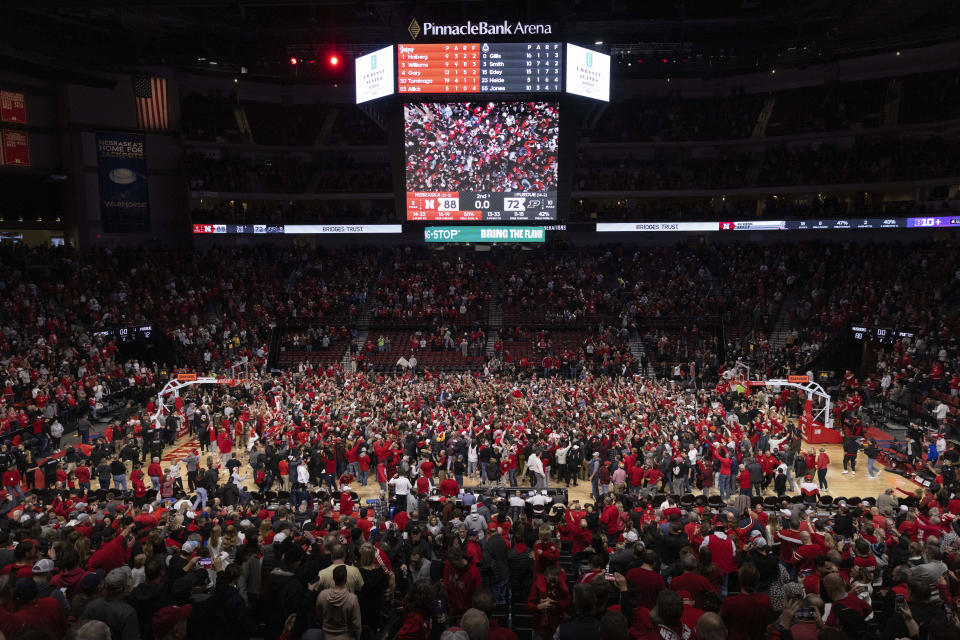 FILE - Nebraska fans rush the court following the team's 88-72 victory over Purdue in an NCAA college basketball game Tuesday, Jan. 9, 2024, in Lincoln, Neb. (AP Photo/Rebecca S. Gratz, File)