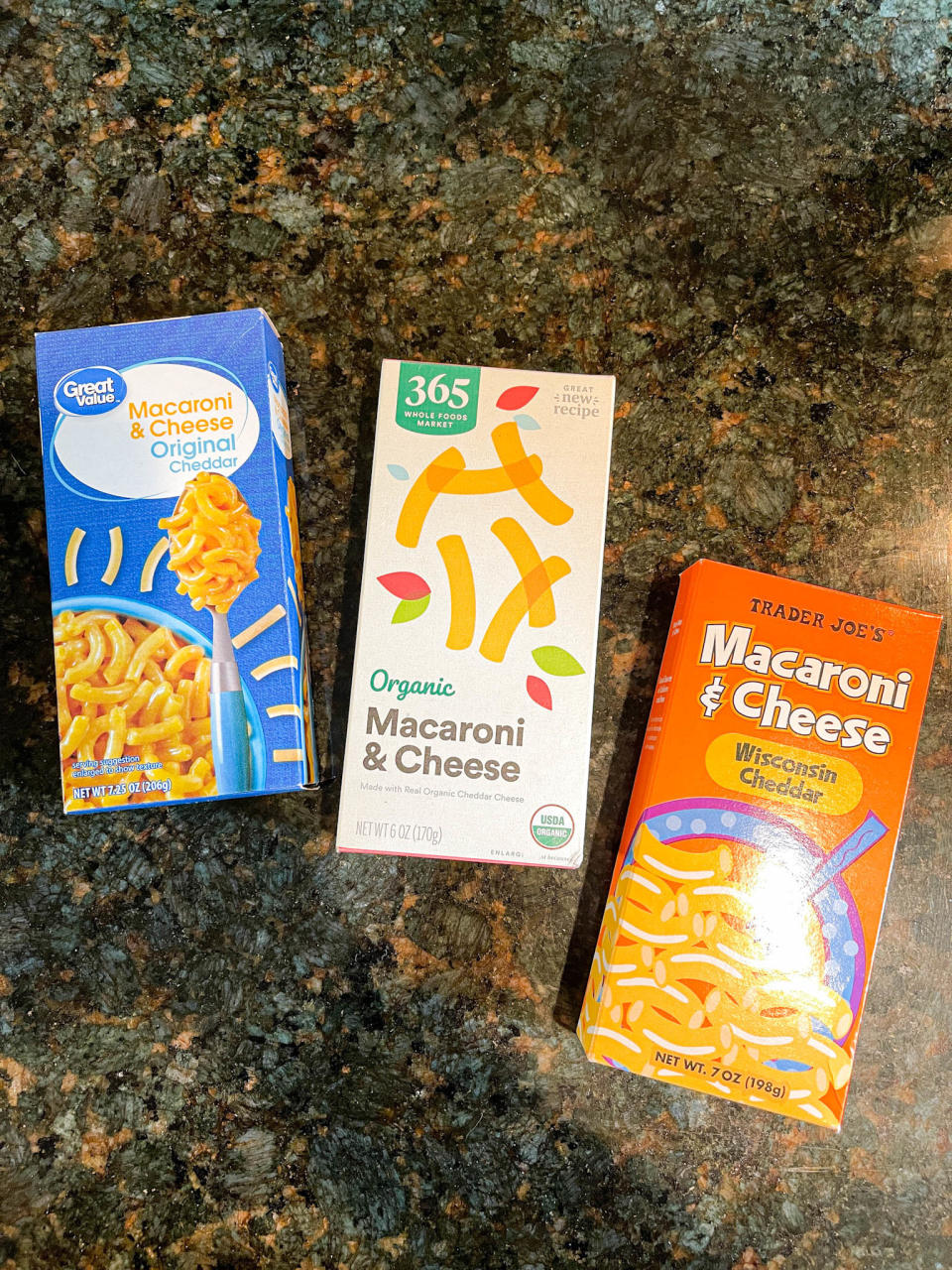 Three mac 'n' cheese boxes: Walmart's, Whole Foods, and Trader Joe's