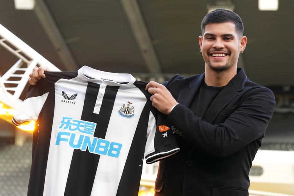 Bruno Guimaraes holds the shirt of Newcastle, who are among those with betting firm sponsorship (Owen Humphreys/PA) (PA Wire)