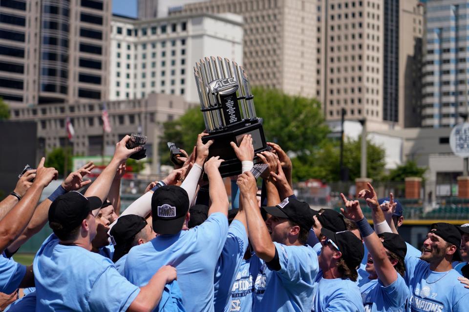 North Carolina celebrates with the ACC baseball tournament trophy after defeating N.C. State in the championship game Sunday at Truist Field in Charlotte.