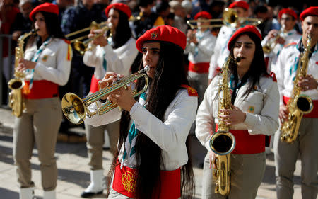 Members of a Palestinian marching band parade during Christmas celebrations at Manger Square outside the Church of the Nativity in Bethlehem, in the Israeli-occupied West Bank December 24, 2018. REUTERS/Raneen Sawafta