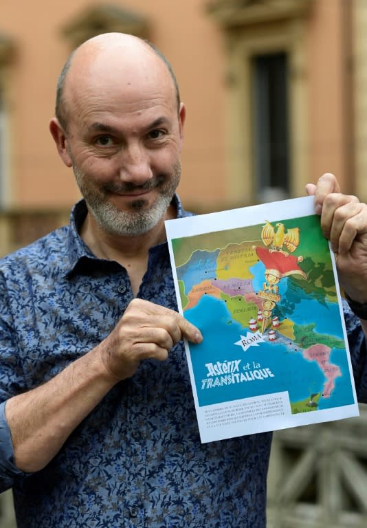 French comics writer Jean-Yves Ferri shows off the future front page of the latest Asterix adventure, "Asterix and the Race through Italy" (showing the French edition title), to hit bookshelves in October